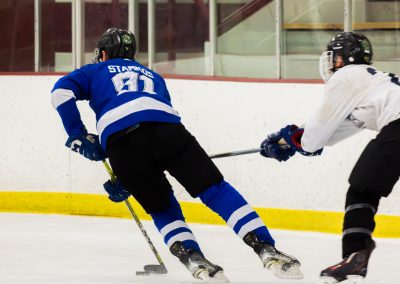 Two hockey players in action on an ice rink.